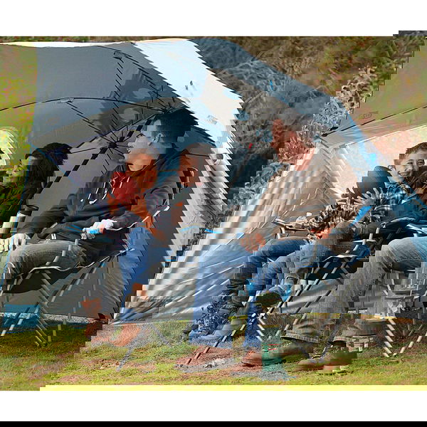 The Sport-Brella XL set up on the beach, anchored in the sand with its side flaps staked out.