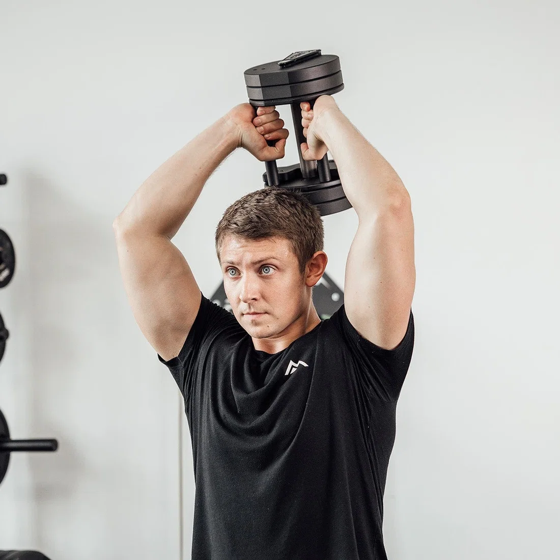Athlete training with REP QuickDraw Adjustable Dumbbell
